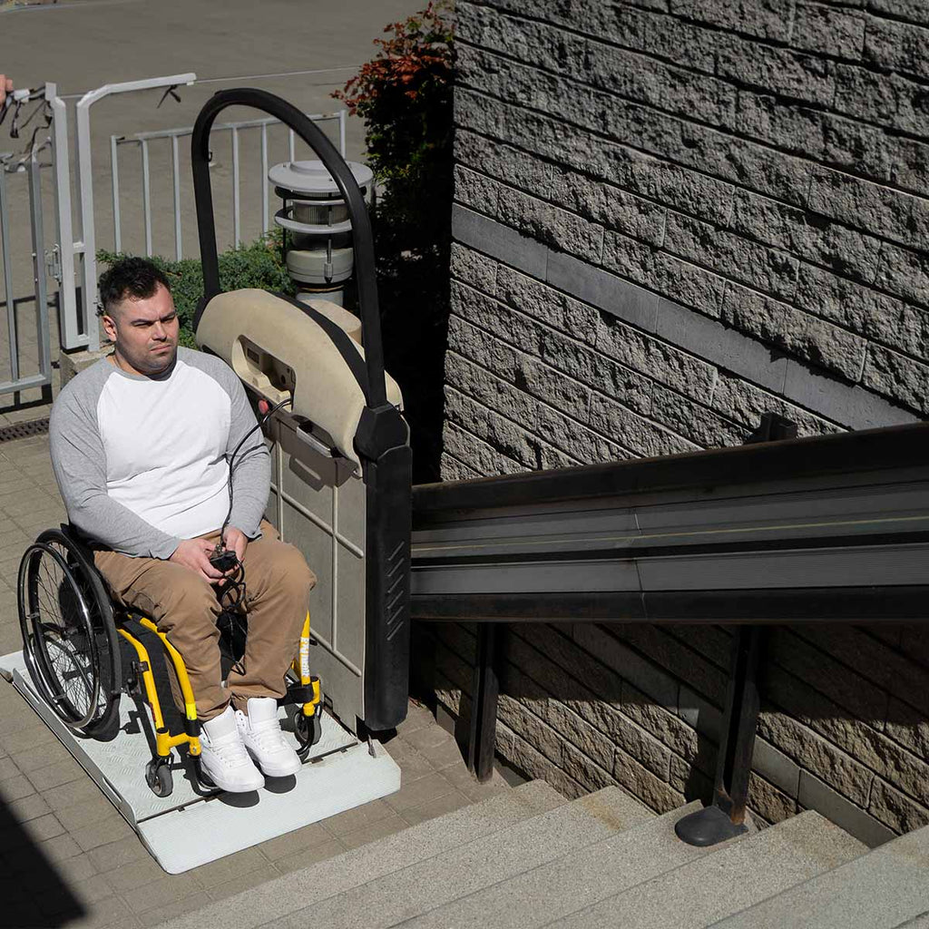Disabled man in wheelchair with home modification to get up stairs. 