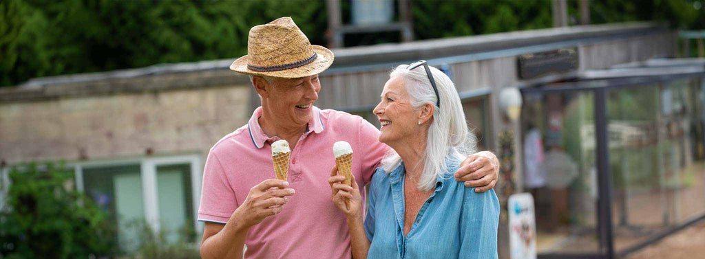Elderly couple enjoying Ice cream together.