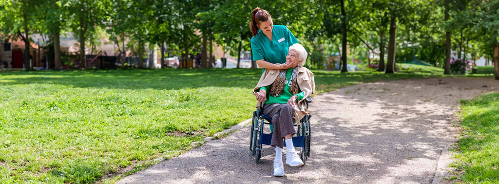 Support Worker having fun with elderly women in wheelchair. 