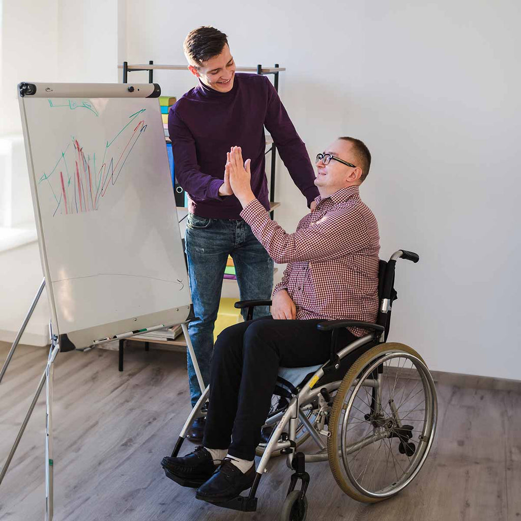 Support worker caring for an elderly man in a wheelchair.