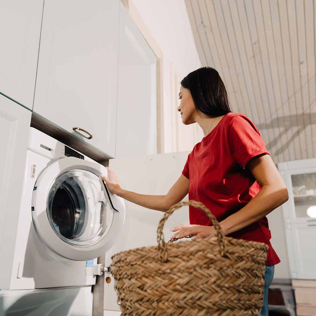 Women doing the laundry for NDIS participant. 