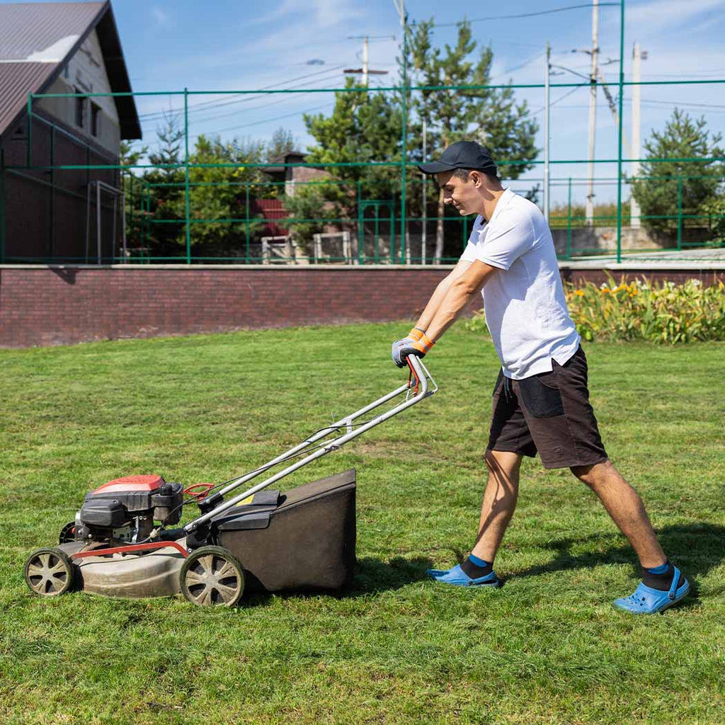Man mowing lawn for NDIS participant. 