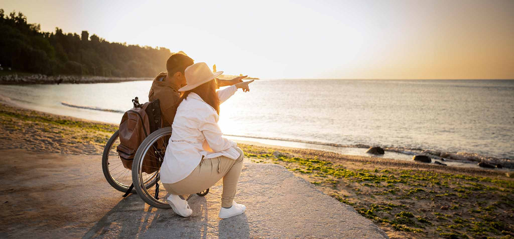 Carer, looking after a man in a wheel chair. 